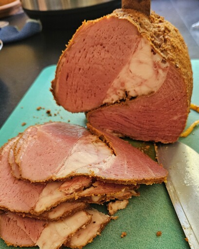 Pastrami with a few pieces sliced off. 