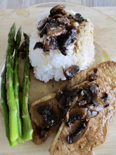 Pork chops, white rice, asparagus and mushroom sauce. 