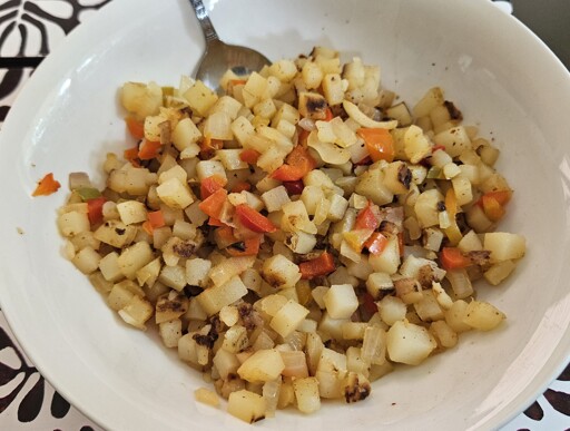 Hashbrowns (cubes) with fried onions and capsicum. 