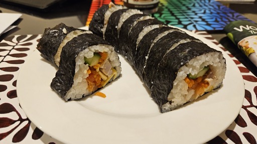 Sliced gimbap on a white plate. 